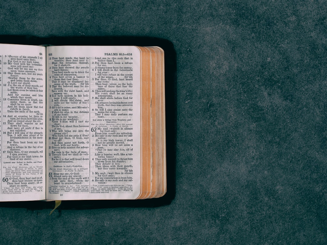 open-pocket-bible-on-green-surface-uiib0bavwfs